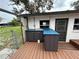 Outdoor kitchen on a wooden deck, offering a practical and attractive space for al fresco dining and entertaining at 775 Liberty St, Englewood, FL 34223