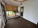 Sunroom boasting a ceiling fan, bamboo blinds, carpet floors and plenty of natural light at 775 Liberty St, Englewood, FL 34223