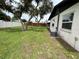 Side yard of a home with mature trees, and an air conditioner at 775 Liberty St, Englewood, FL 34223