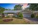 Charming single-story home with well-manicured landscaping and a two-car garage at sunset at 7810 San Juan Ave, Bradenton, FL 34209