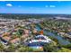 Stunning aerial view of condo complex along the bay, showcasing community pool and well-manicured landscaping at 835 S Osprey Ave # 415, Sarasota, FL 34236