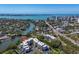 Stunning aerial view showcases condo complex, waterway access, and scenic cityscape backdrop at 835 S Osprey Ave # 415, Sarasota, FL 34236