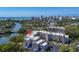 Aerial view of a condo complex with blue awnings, lush greenery, and waterfront views at 835 S Osprey Ave # 415, Sarasota, FL 34236