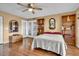 Light bedroom features hardwood floors, a ceiling fan, and built-in bookshelves at 835 S Osprey Ave # 415, Sarasota, FL 34236