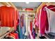 Organized walk-in closet with hanging racks, shelves, and colorful clothes at 835 S Osprey Ave # 415, Sarasota, FL 34236