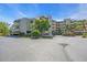 Modern condo building with manicured landscaping, parking area, and beautiful architectural details at 835 S Osprey Ave # 415, Sarasota, FL 34236