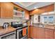 Cozy kitchen featuring wood cabinets, stainless steel appliances, and a double sink with counter space at 835 S Osprey Ave # 415, Sarasota, FL 34236