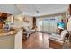 Bright living room with wood floors, comfortable seating, and natural light from patio doors at 835 S Osprey Ave # 415, Sarasota, FL 34236