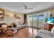 Cozy living room featuring hardwood floors, comfortable seating, and balcony access at 835 S Osprey Ave # 415, Sarasota, FL 34236