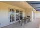 Inviting patio with outdoor seating and views from multi-paneled doors at 835 S Osprey Ave # 415, Sarasota, FL 34236