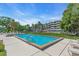 Community pool with blue water, surrounded by lush landscaping and building in background at 835 S Osprey Ave # 415, Sarasota, FL 34236