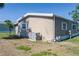 View of the back exterior of the single Gathering home highlighting the air conditioning unit and utilities at 8402 Princess Ct, Palmetto, FL 34221
