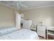 Bedroom with hardwood floors, two twin beds, a white dresser, and bright natural light at 8402 Princess Ct, Palmetto, FL 34221
