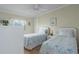 Twin bedroom with two beds, wood floors, and bright natural light from a window at 8402 Princess Ct, Palmetto, FL 34221