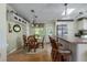 Cozy dining area featuring a glass-top table, rattan chairs, and overhead lighting at 8402 Princess Ct, Palmetto, FL 34221