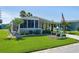 Single-story home with a covered driveway, an enclosed patio, and an American flag waving out front at 8402 Princess Ct, Palmetto, FL 34221
