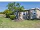 Manicured lawn and mature palm trees add charm to this well maintained single Gathering home at 8402 Princess Ct, Palmetto, FL 34221
