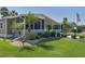 This single Gathering home boasts mature palm trees, a screened in patio, and meticulous landscaping at 8402 Princess Ct, Palmetto, FL 34221
