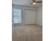 Bedroom with carpet, a ceiling fan, and a window with blinds next to a large closet with bi-fold doors at 859 Audubon Dr # 859, Bradenton, FL 34209