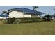 Attractive home exterior featuring a well-manicured lawn, vibrant green bushes, and a blue metal roof at 859 Audubon Dr # 859, Bradenton, FL 34209
