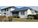 Lovely exterior view of a home with a metal roof, screened in porch, and well-maintained landscaping at 859 Audubon Dr # 859, Bradenton, FL 34209