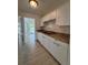 Functional kitchen with white cabinets, laminate countertops, wood floors, and ample natural light at 859 Audubon Dr # 859, Bradenton, FL 34209