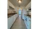 Well-organized kitchen with white appliances, cabinets, laminate countertops, and durable wood floors at 859 Audubon Dr # 859, Bradenton, FL 34209