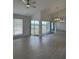 Inviting living room featuring beautiful wood flooring, bright windows, and sliding glass doors with water view at 859 Audubon Dr # 859, Bradenton, FL 34209