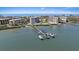 Aerial view showing buildings, docks and boats at 8735 Midnight Pass Rd # 306B, Sarasota, FL 34242