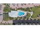 Overhead shot of pool and clubhouse surrounded by lush landscaping and brick paver walkways at 8735 Midnight Pass Rd # 306B, Sarasota, FL 34242