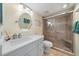 Updated bathroom featuring a glass shower, a white vanity, and decorative accents at 8735 Midnight Pass Rd # 306B, Sarasota, FL 34242