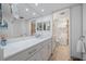 Bathroom with updated vanity, mirror, and a walk-in shower at 8735 Midnight Pass Rd # 306B, Sarasota, FL 34242