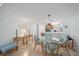 Dining area featuring a glass table, rattan chairs, with decor and an open view to the kitchen with modern appliances at 8735 Midnight Pass Rd # 306B, Sarasota, FL 34242