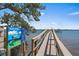 Dock extends into the water with clear signage, offering access to boating activities and scenic views at 8735 Midnight Pass Rd # 306B, Sarasota, FL 34242