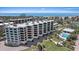 Exterior angle showing the building with a pool and hot tub, along with an approximate unit location at 8735 Midnight Pass Rd # 306B, Sarasota, FL 34242