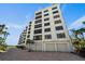 Exterior shot of the condos with garage parking and well-maintained landscaping at 8735 Midnight Pass Rd # 306B, Sarasota, FL 34242