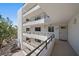 White building exterior view highlighting multiple floors, windows and entry door at 8735 Midnight Pass Rd # 306B, Sarasota, FL 34242