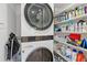 Laundry room features a stacked washer/dryer with shelves at 8735 Midnight Pass Rd # 306B, Sarasota, FL 34242