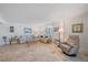 Comfortable living room featuring neutral tones, tile floors, and cozy seating arrangements at 8735 Midnight Pass Rd # 306B, Sarasota, FL 34242