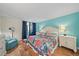 Main bedroom with hardwood floors and a private balcony featuring blue accents at 8735 Midnight Pass Rd # 306B, Sarasota, FL 34242