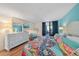 Bright main bedroom featuring a balcony and hardwood floors with designer furniture at 8735 Midnight Pass Rd # 306B, Sarasota, FL 34242