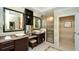 Luxury bathroom boasting double sinks, a TV, a glass shower and a decorative tile floor at 915 Seaside Dr # 613 Weeks 32-33, Sarasota, FL 34242