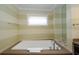 Modern bathtub with stylish fixtures and a nearby window, offering a relaxing bathing experience at 915 Seaside Dr # 613 Weeks 32-33, Sarasota, FL 34242