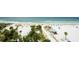 Scenic beach view with white sands, palm trees, and oceanfront lounging areas in a tropical setting at 915 Seaside Dr # 613 Weeks 32-33, Sarasota, FL 34242