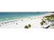 Expansive beach view with white sands, palm trees, and clear blue waters on a sunny day at 915 Seaside Dr # 613 Weeks 32-33, Sarasota, FL 34242