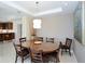 Bright dining room with a large round table, modern chandelier, and adjacent kitchen at 915 Seaside Dr # 613 Weeks 32-33, Sarasota, FL 34242