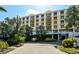 Multi-story building exterior with balconies, tropical landscaping, and covered entrance at 915 Seaside Dr # 613 Weeks 32-33, Sarasota, FL 34242