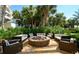 Inviting outdoor fire pit with comfortable seating surrounded by lush tropical landscaping at 915 Seaside Dr # 613 Weeks 32-33, Sarasota, FL 34242