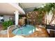 Luxurious indoor hot tub featuring a stone waterfall and lush greenery at 915 Seaside Dr # 613 Weeks 32-33, Sarasota, FL 34242
