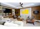 Cozy living room featuring wood-paneled accent wall, modern lighting, and plush seating arrangements at 915 Seaside Dr # 613 Weeks 32-33, Sarasota, FL 34242
